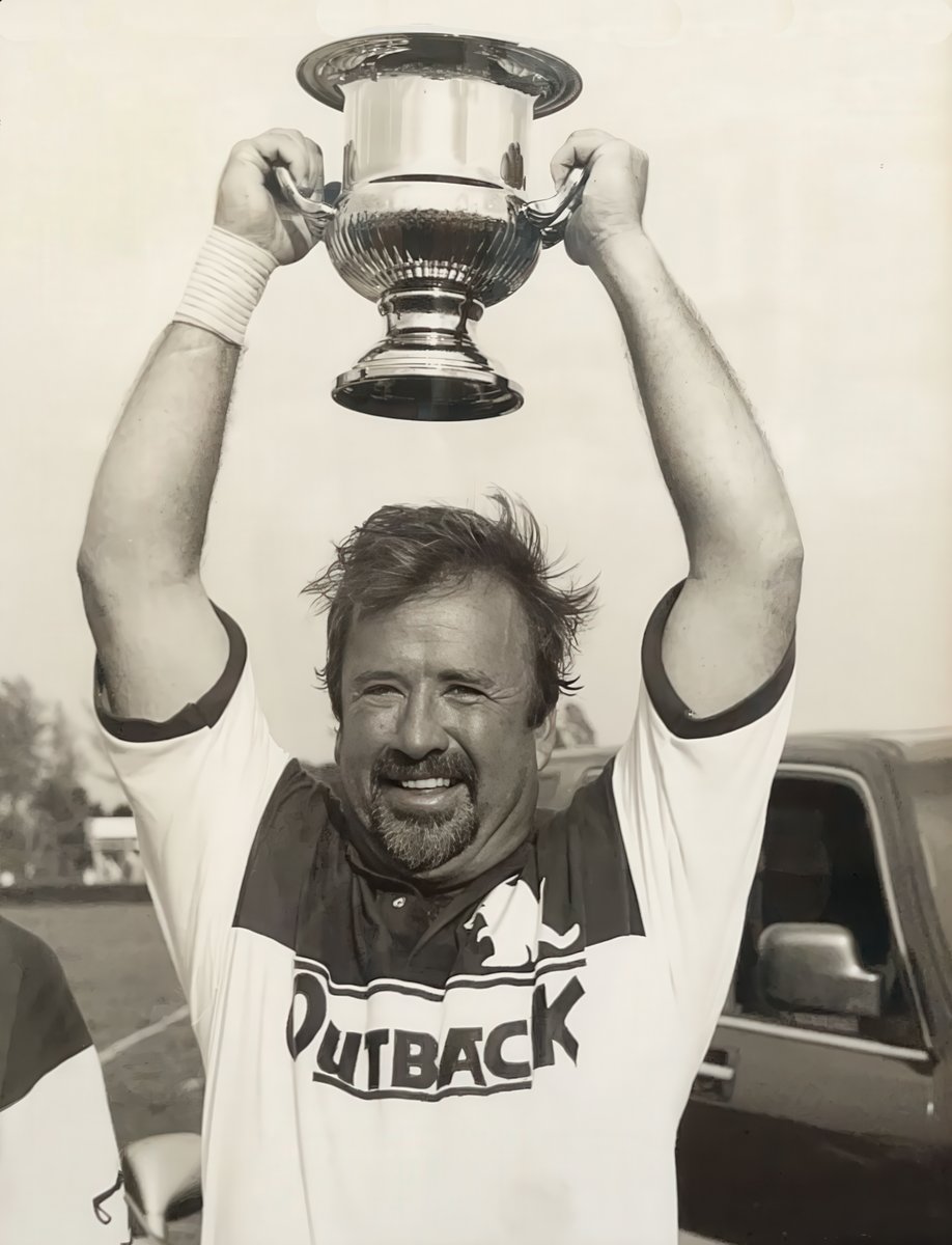 Trophy in hand.